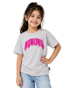 A young girl with dark hair in a ponytail smiling while wearing a light gray heather t-shirt with a vibrant pink 'MUNUDO' graphic on the chest, paired with light blue jeans, against a plain light gray background.